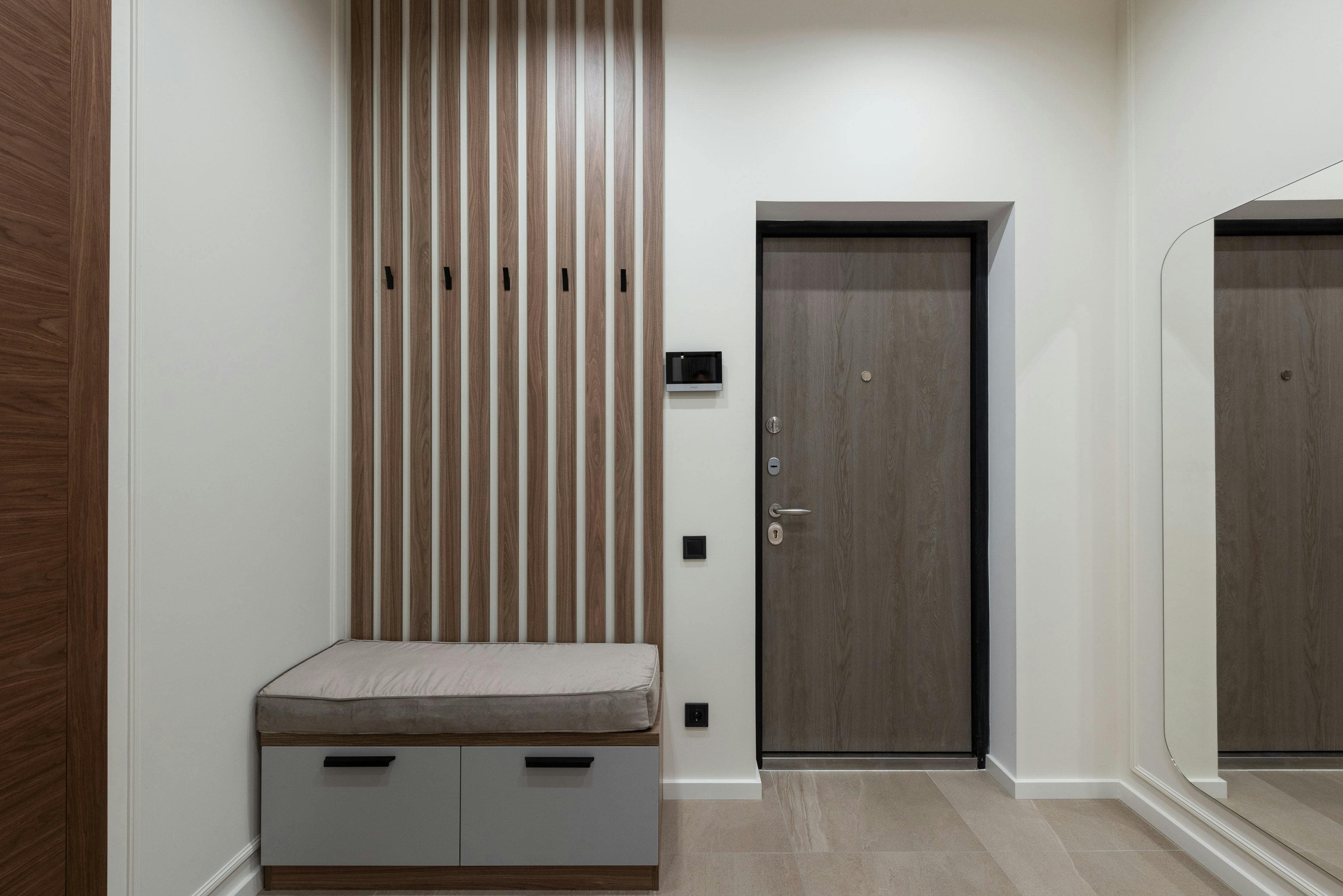 Wooden panel wall around the door with trims